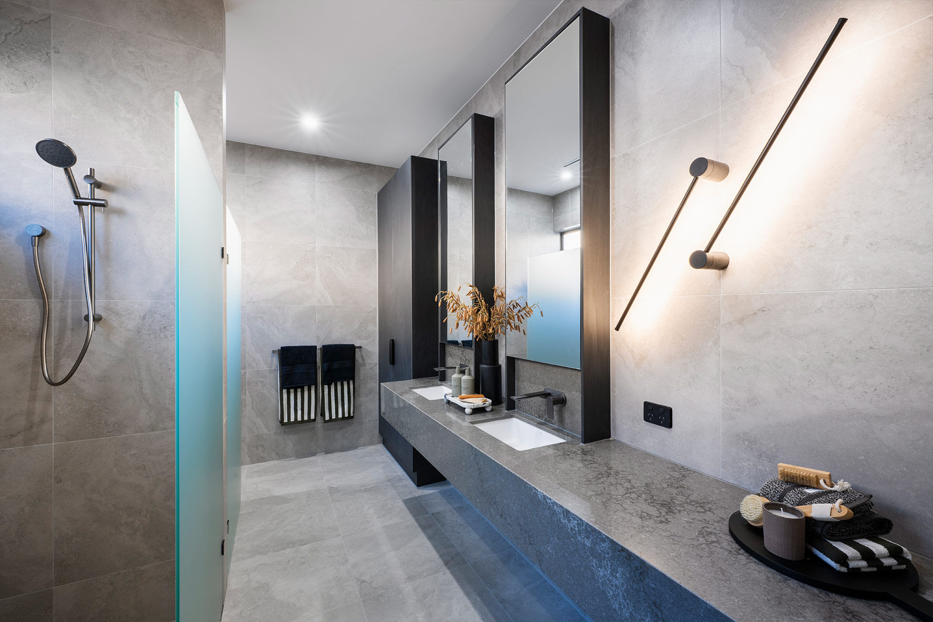 Grand Prize bathroom ensuite with grey tiles and black accents