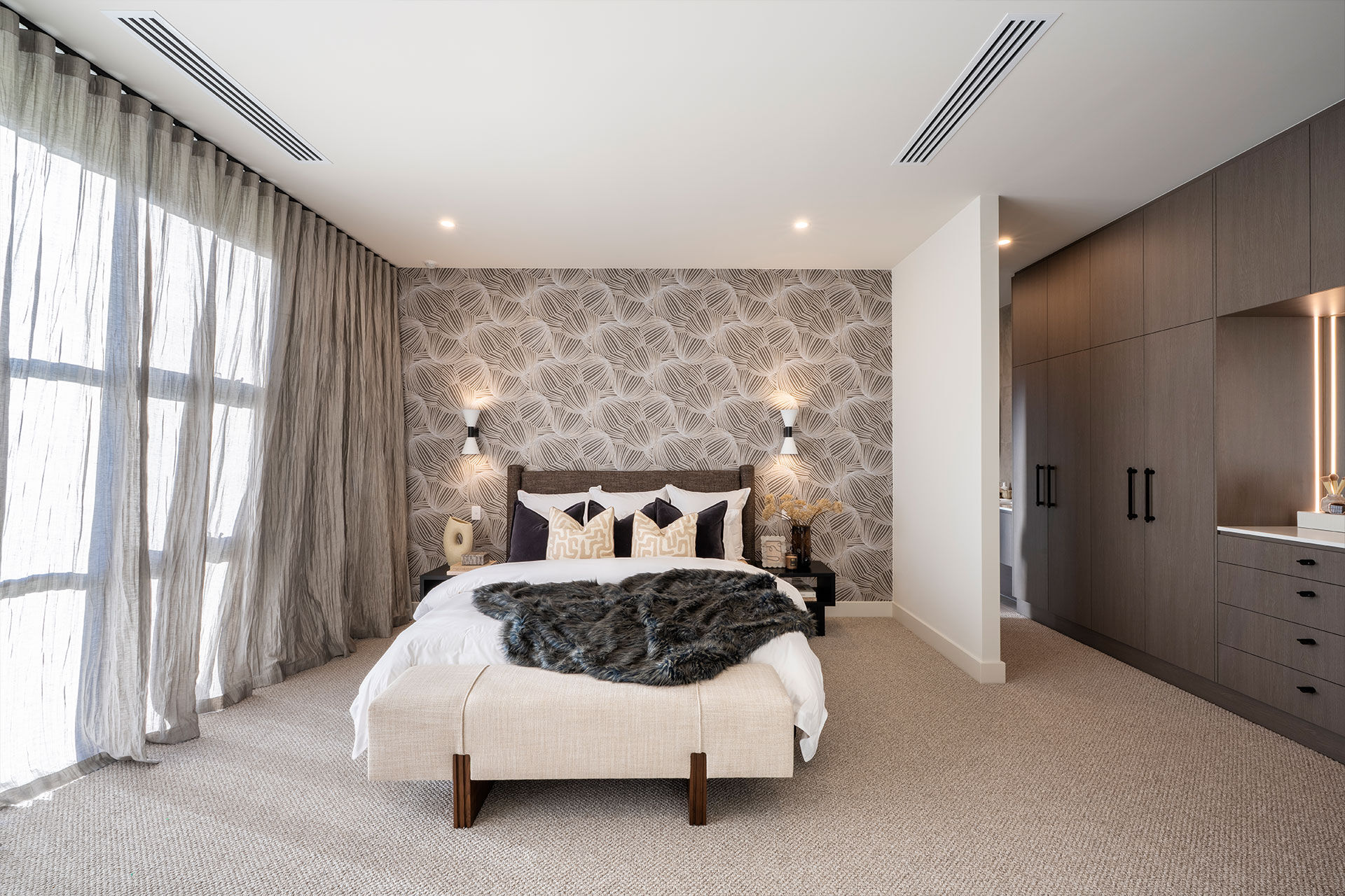 Main bedroom stylein creams and browns with intricate wallpaper