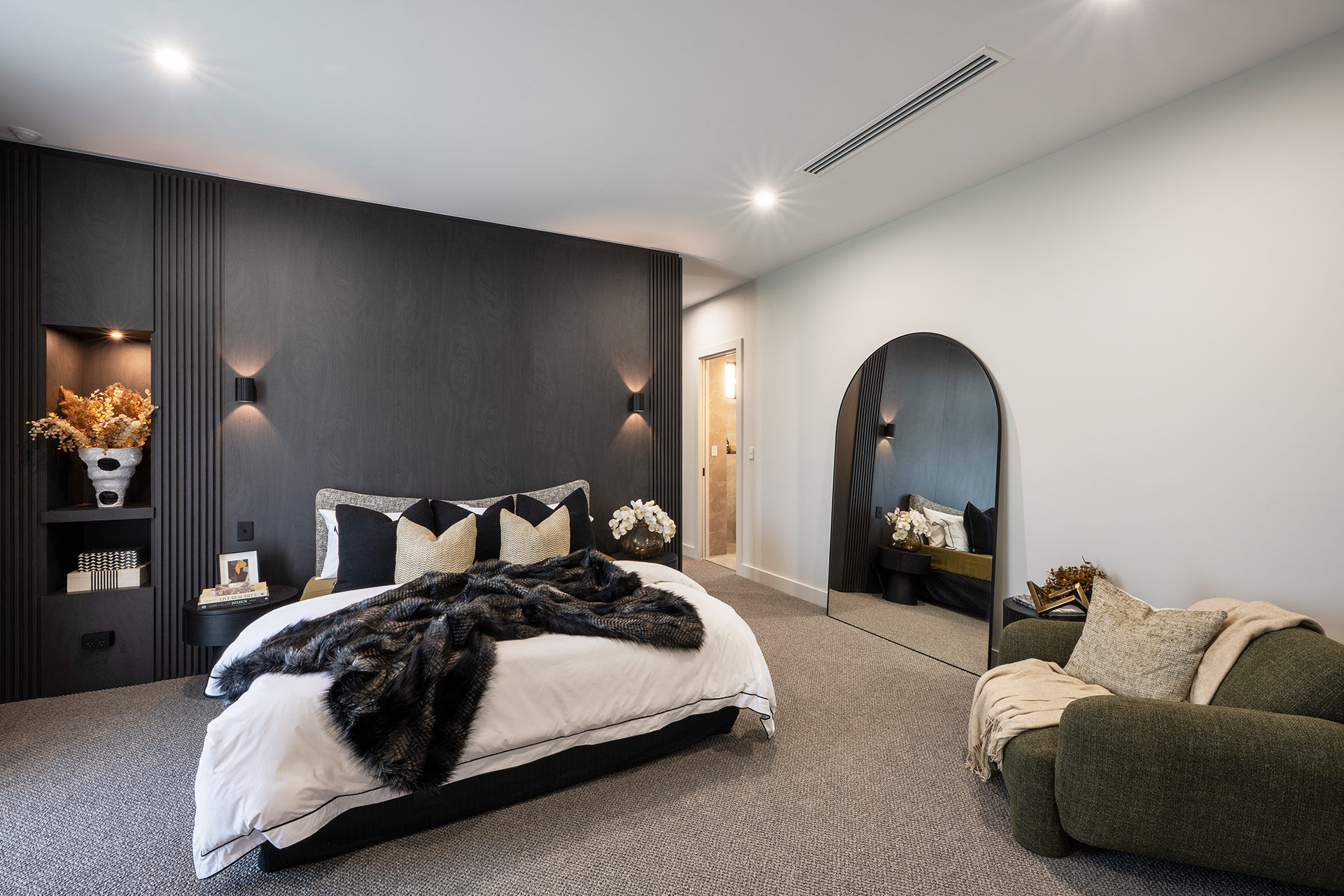 Grand Prize main bedroom with dark cabinetry and plush furnishings