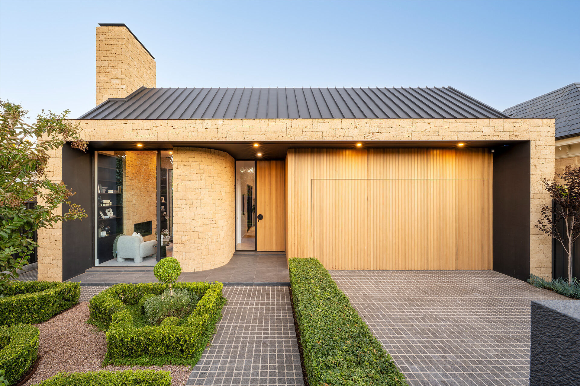 Grand Prize home Sept 2025 singlestory house with warm timber accents and formal hedged front garden