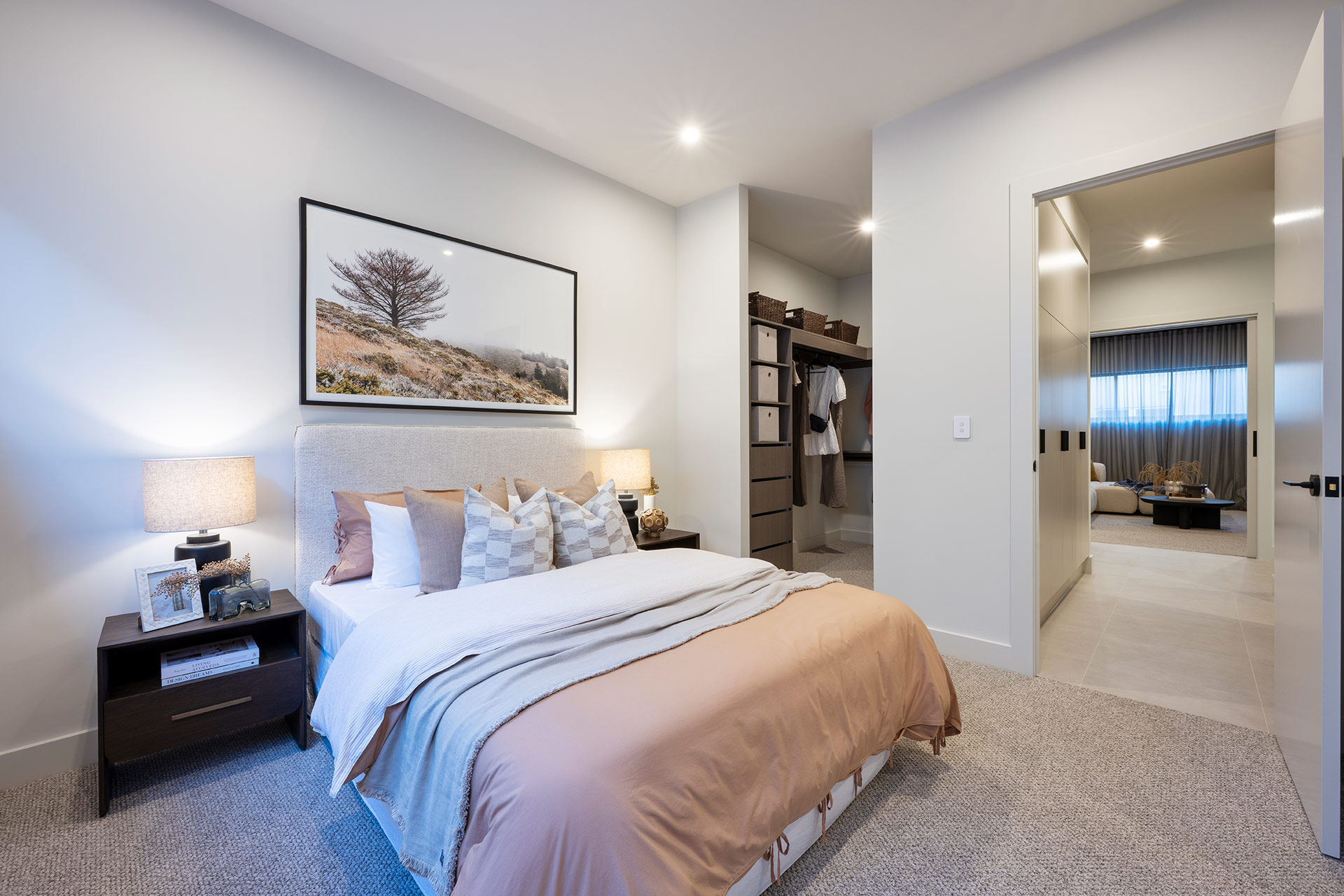 Bedroom with soft peach bed linen open walk in robe