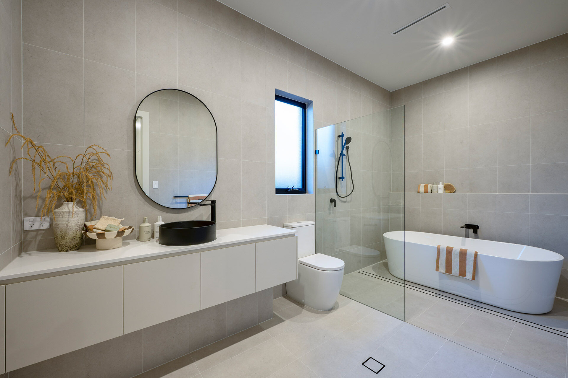 Light bathroon with feature black tapware shower and bath