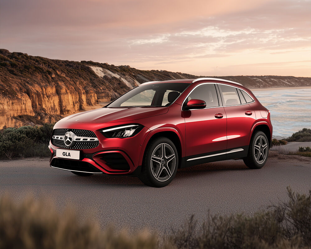 Red Mercedes Benz GLA Luxury car parked on scenic coastal lookout at dusk