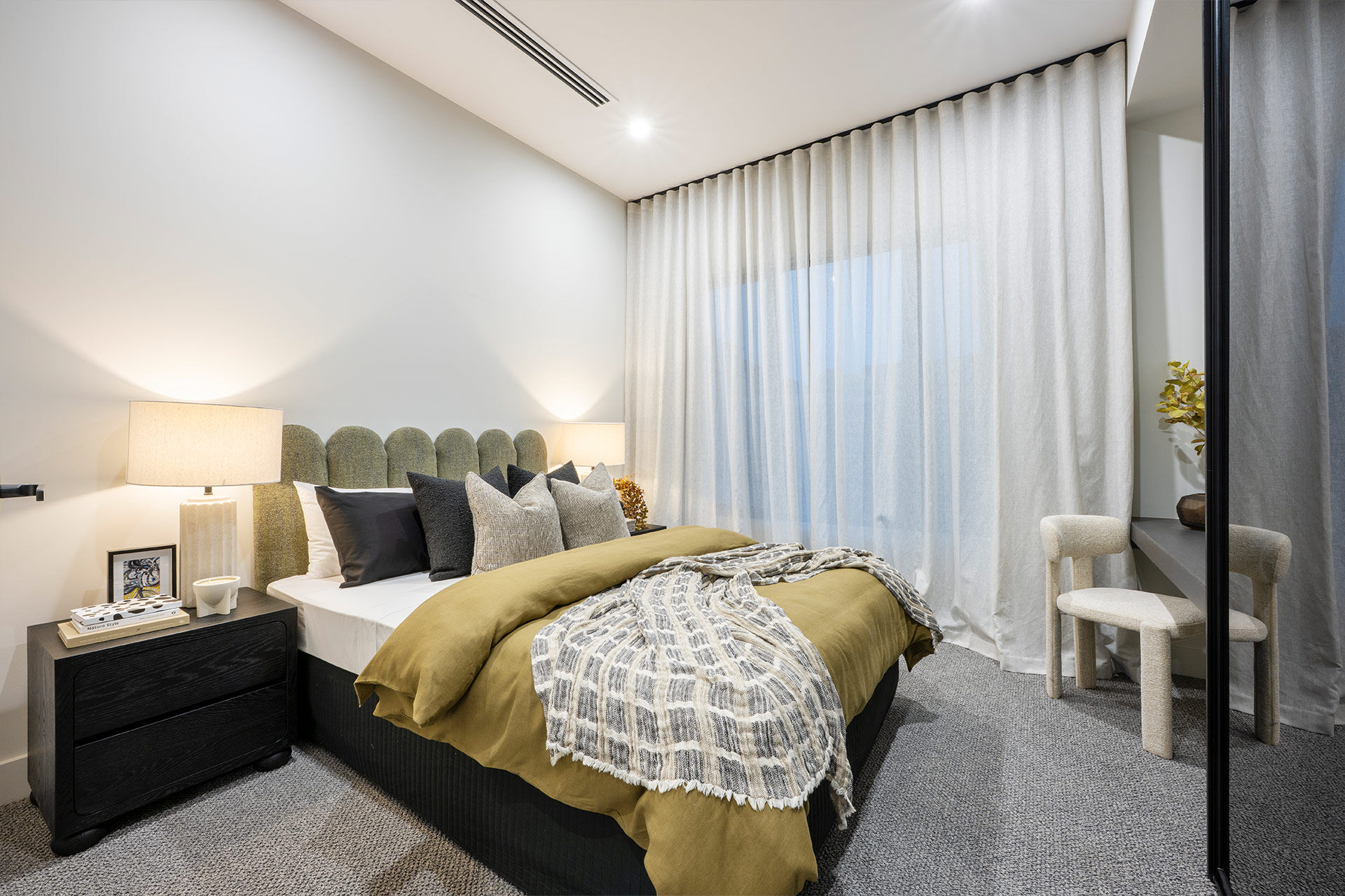 Grand Prize bedroom with olive and grey bedding and soft linen curtains