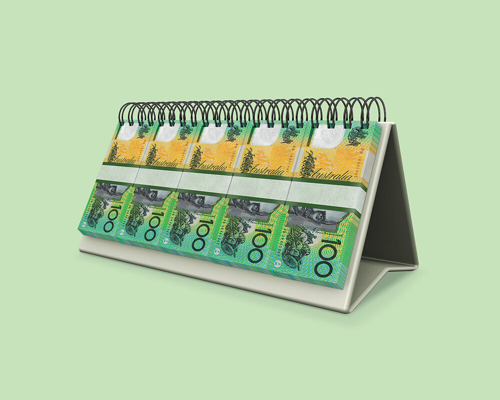 Bundles of hundred dollar notes on spiral bound calendar pale green background