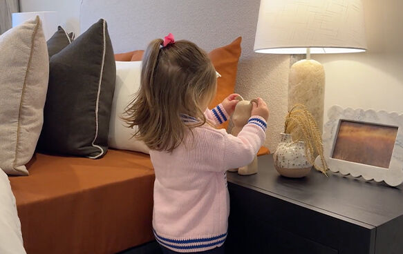 Child with teddy bear in grand prize bedroom