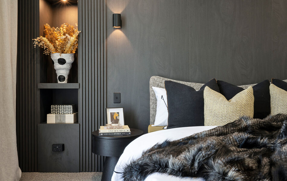 Detail of main bedroom bed with dark timber headboard