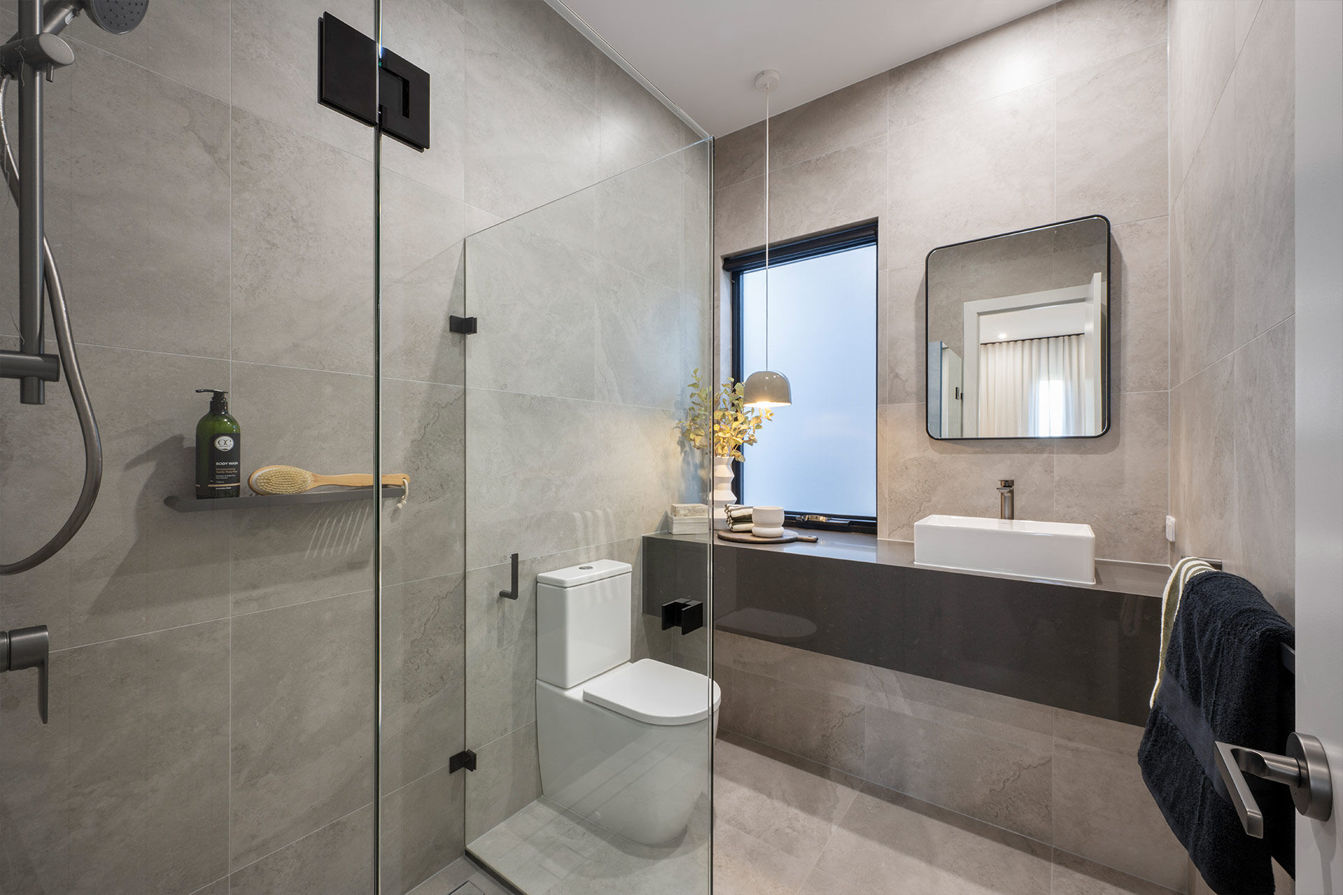 Grand Prize small bathroom ensuite with grey tiles and dark vanity