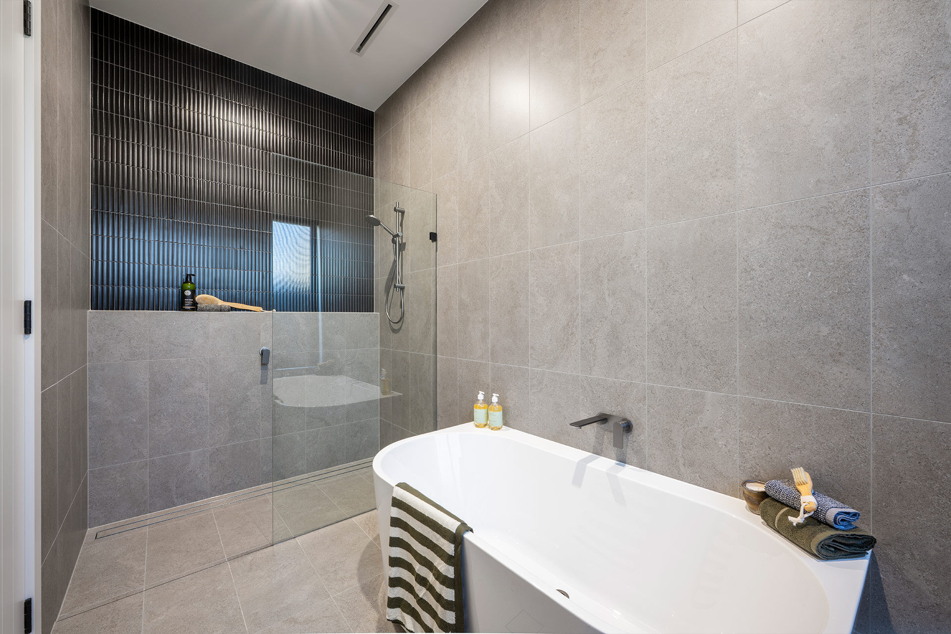 Grand Prize wet room with grey tiles and black accents