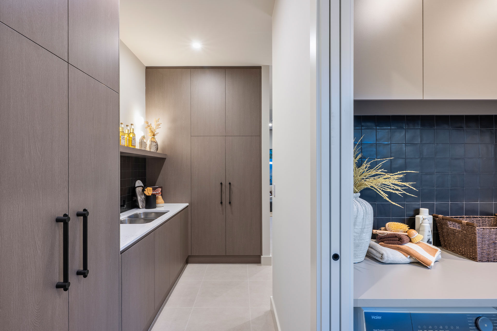 Butlers pantry cupboard and bench area connecting to the laundry room