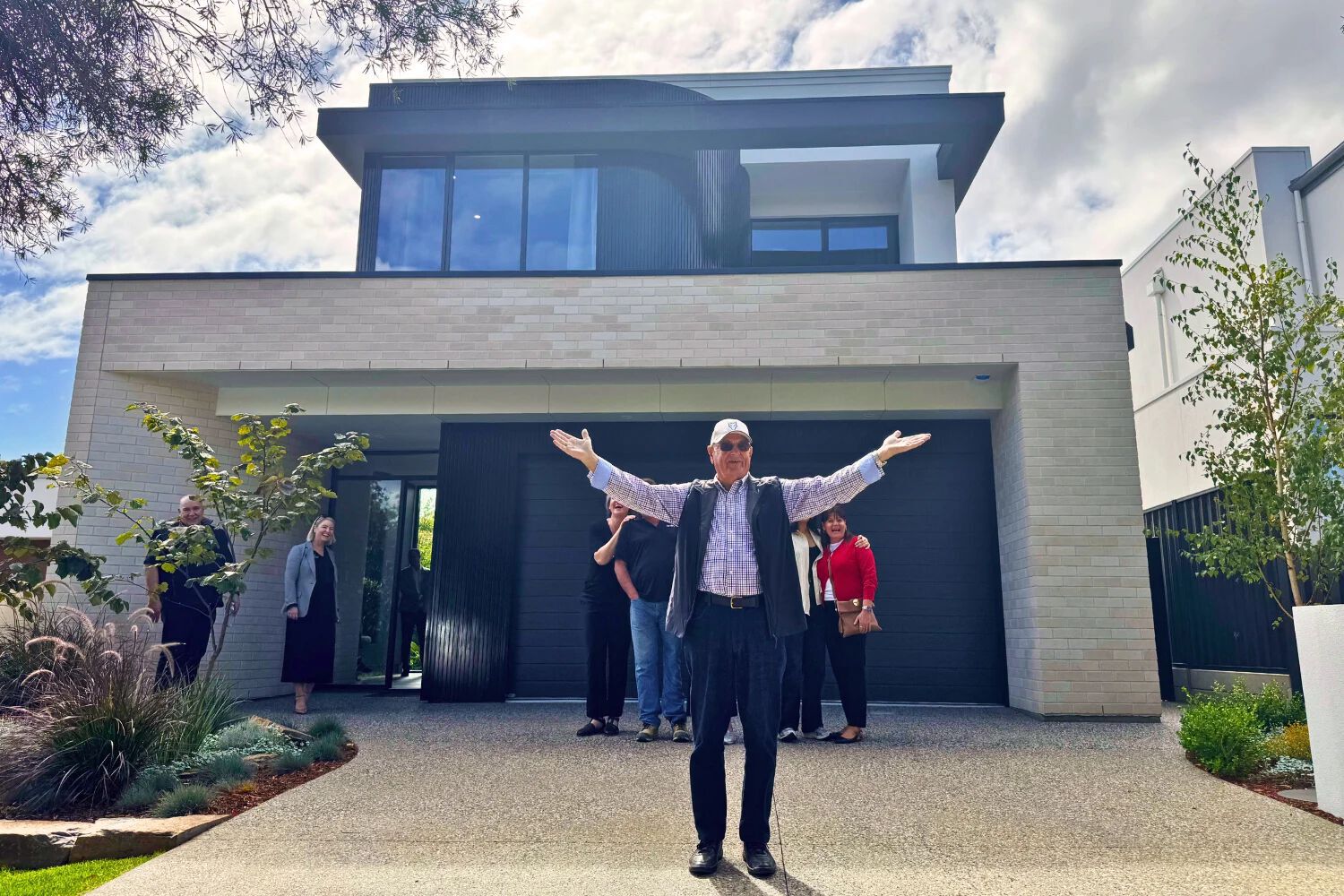 2025 lottery 1 winner celebrates in front of grand prize home