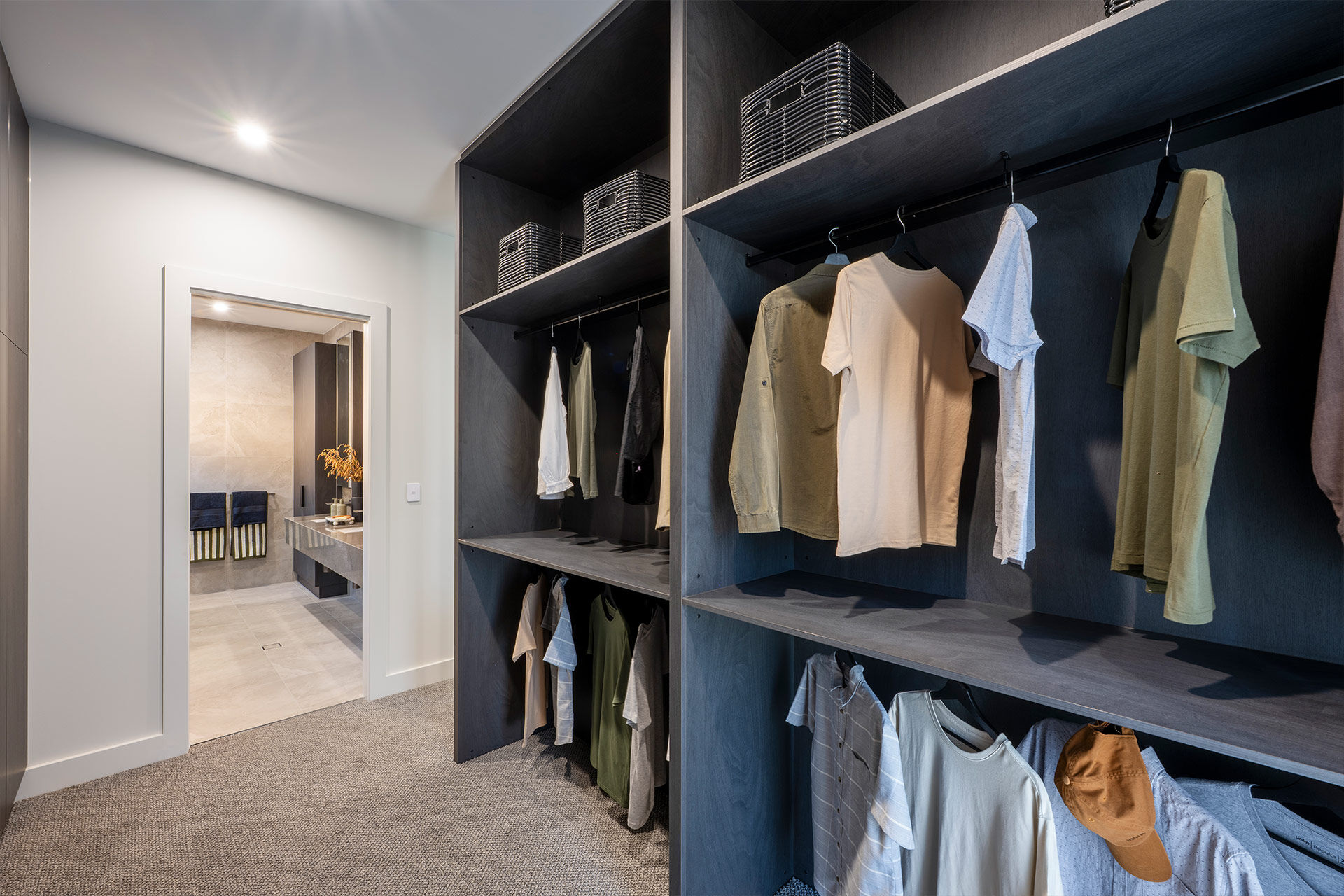 Grand Prize dark wardrobes with hanging tshirts with open door to ensuite