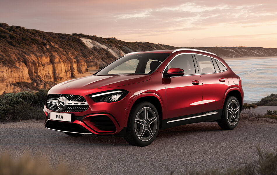 Red Mercedes Benz GLA Luxury car parked on scenic coastal lookout at dusk