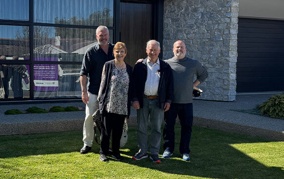 Winner Tony in front of prize home