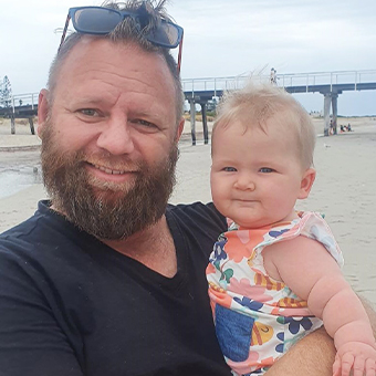 Image of father and young daughter on the beach